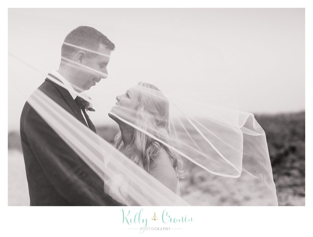 A couple kiss behind a veil  | Kelly Cronin Photography | Cape Cod Wedding Photographer