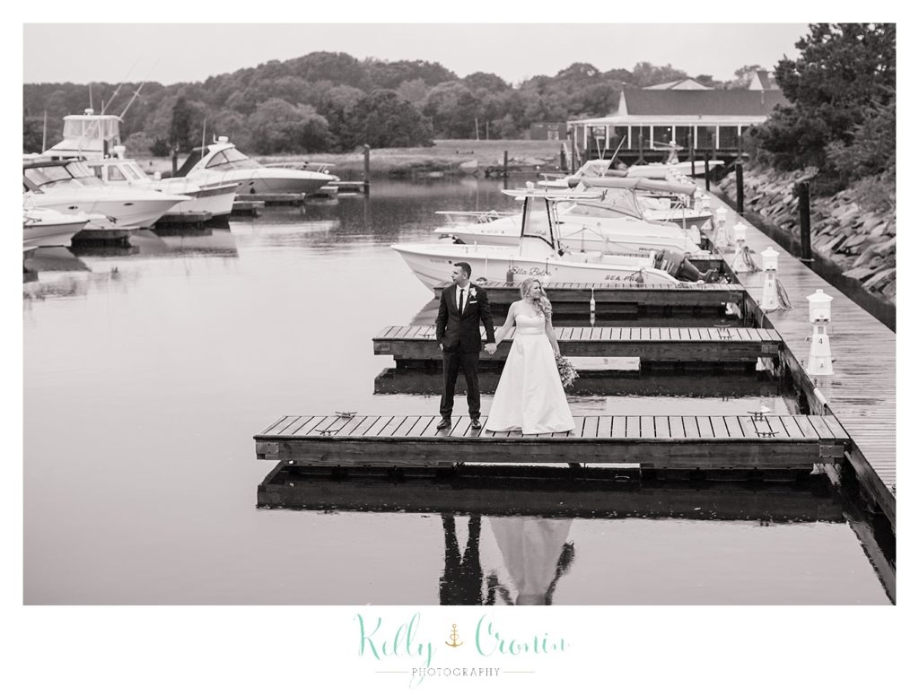 A couple stand on a pier  | Kelly Cronin Photography | Cape Cod Wedding Photographer