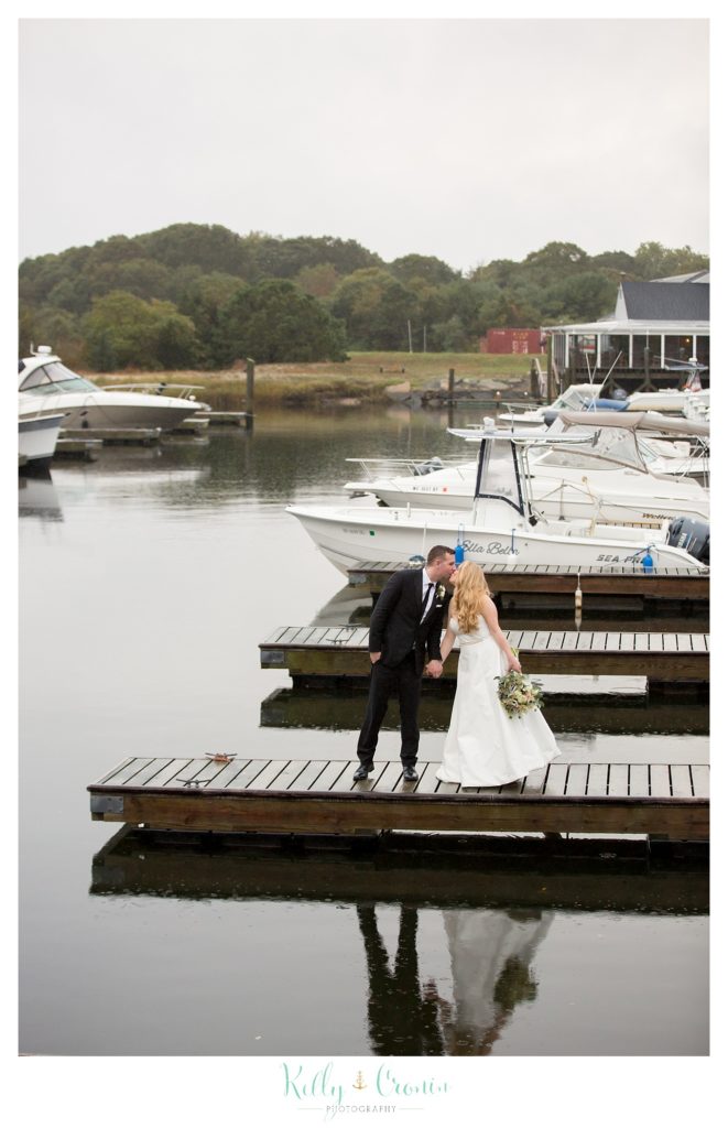 A couple kiss on a pier  | Kelly Cronin Photography | Cape Cod Wedding Photographer