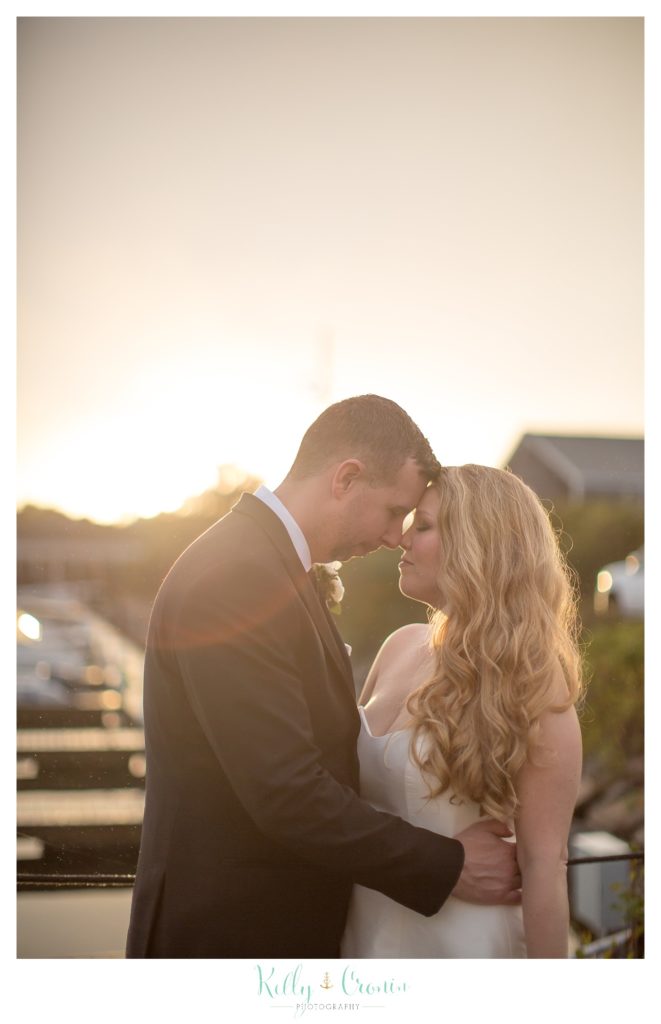 A man draws his wife close  | Kelly Cronin Photography | Cape Cod Wedding Photographer