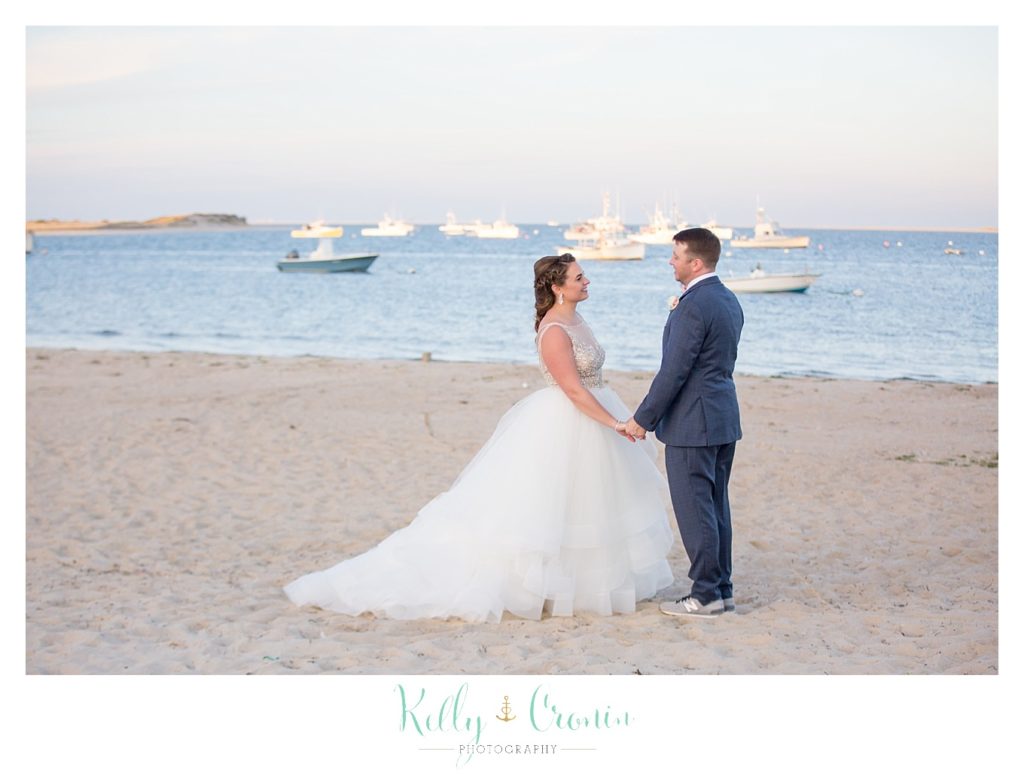 A couple is holding hands | Kelly Cronin Photography | Cape Cod Wedding Photographer
