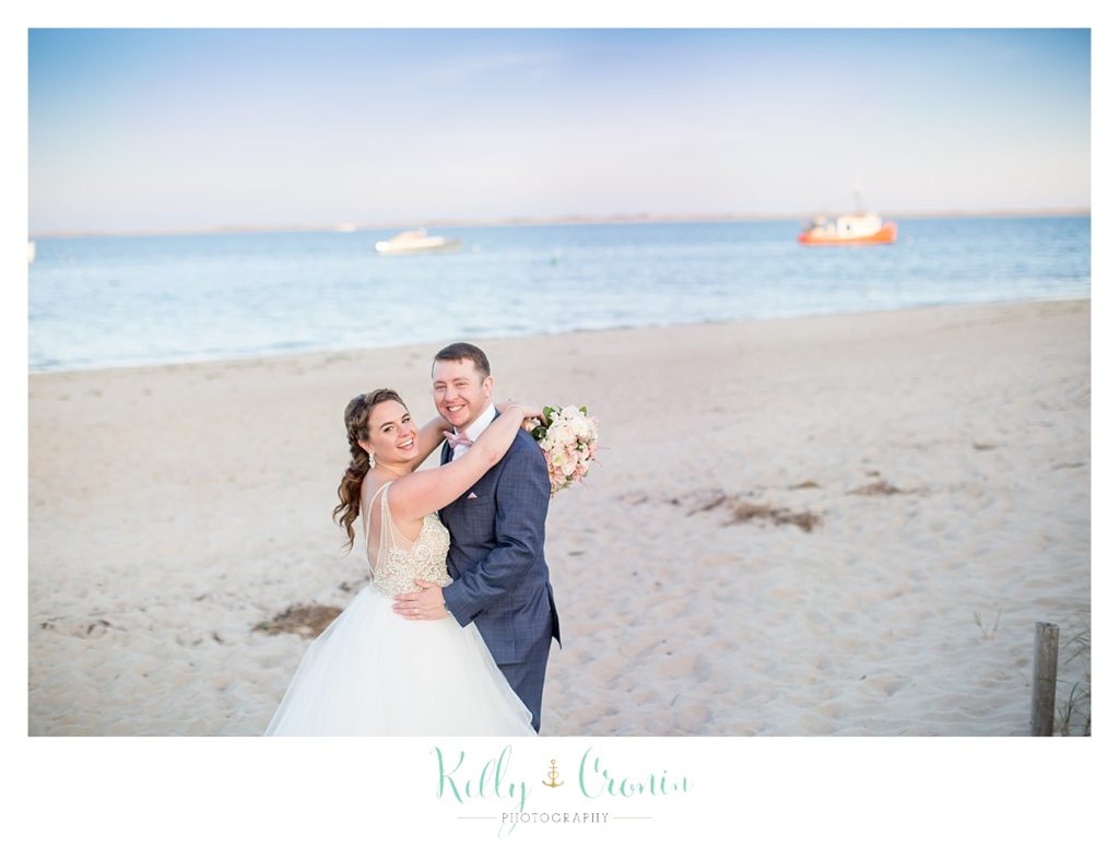 A bride wraps her arms around her groom | Kelly Cronin Photography | Cape Cod Wedding Photographer