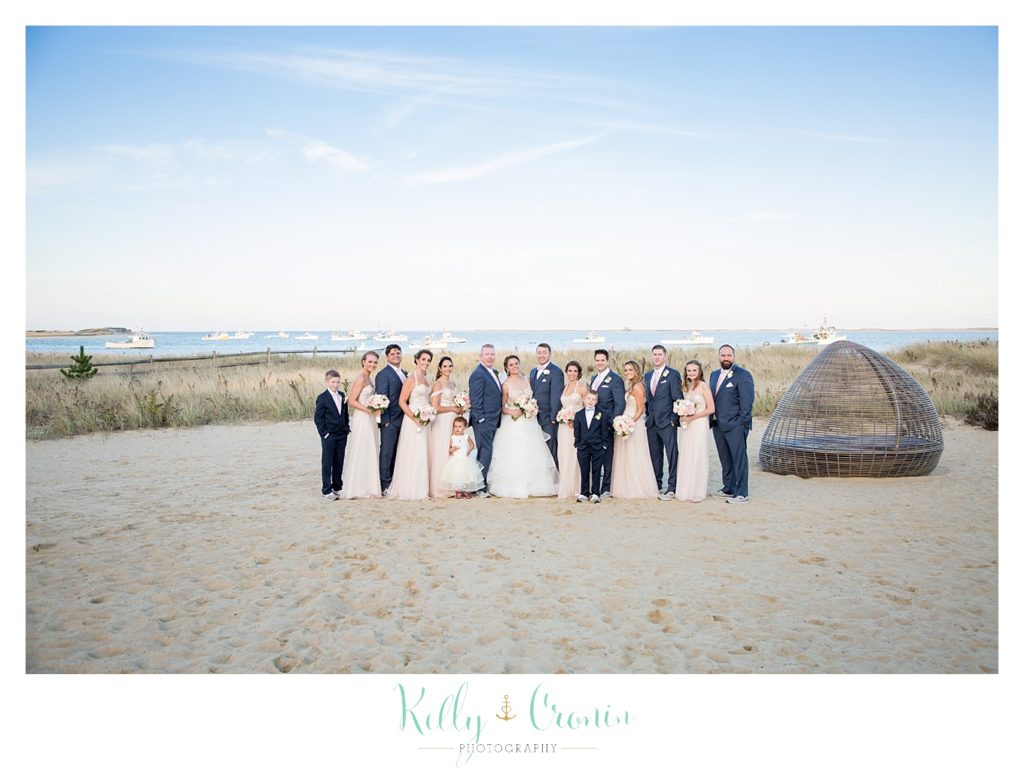 A bride stands with the groomsmen | Kelly Cronin Photography | Cape Cod Wedding Photographer