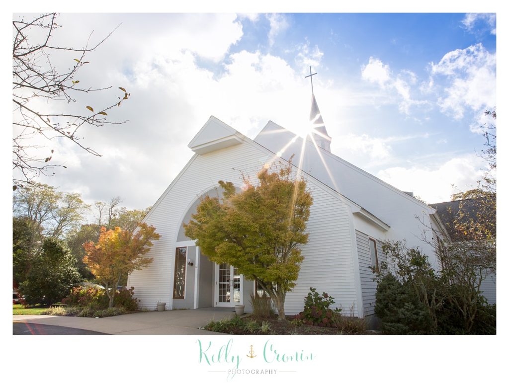 The sun shines over a church | Kelly Cronin Photography | Cape Cod Wedding Photographer