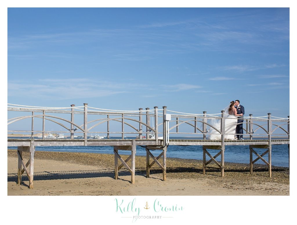 A couple stand on a pier | Kelly Cronin Photography | Cape Cod Wedding Photographer