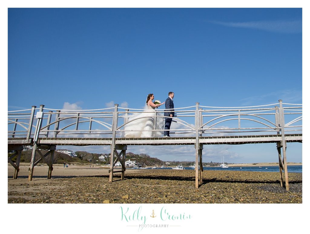 A couple walk on a pier | Kelly Cronin Photography | Cape Cod Wedding Photographer