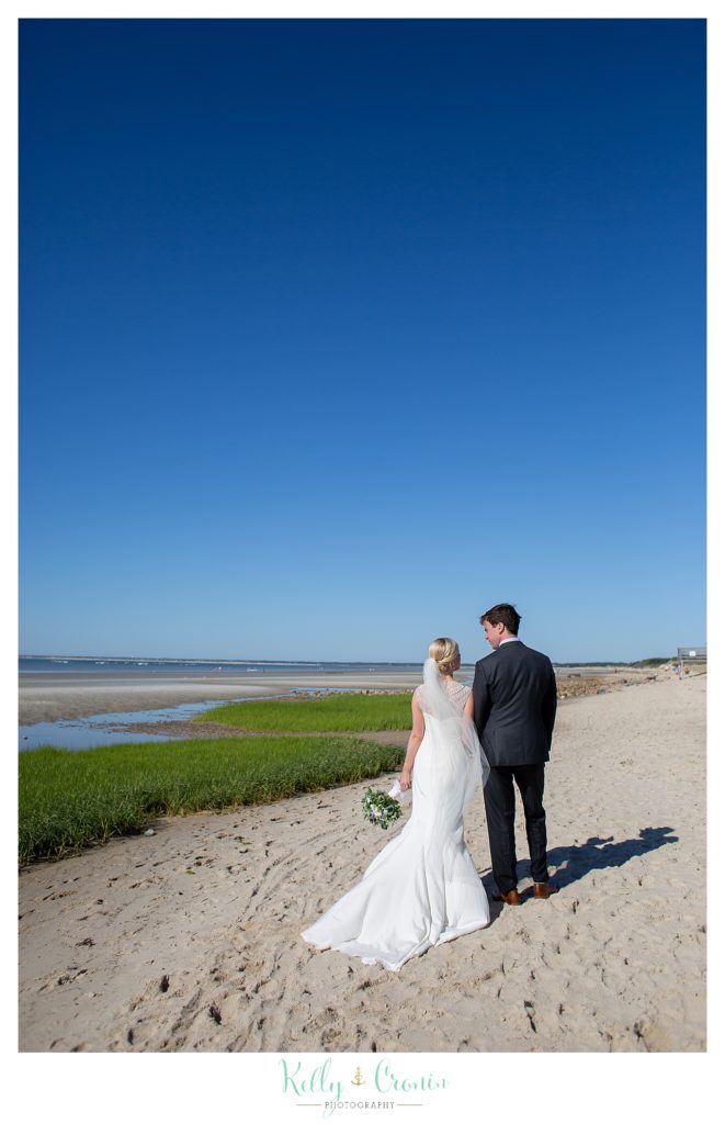A couple look out into the ocean | Kelly Cronin Photography | Ocean Edge Resort and Golf Club