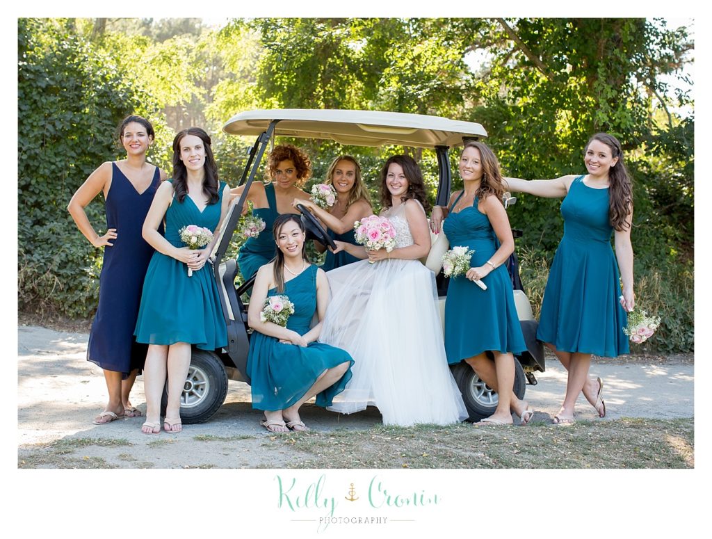 A bridal party sits on a golf cart | Wedding Photographer in Cape Cod | Kelly Cronin Photography