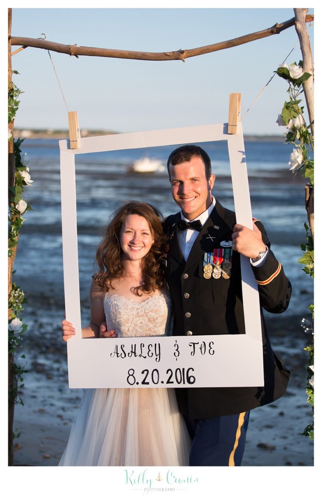 A couple pose for a photo in a frame | Wedding Photographer in Cape Cod | Kelly Cronin Photography