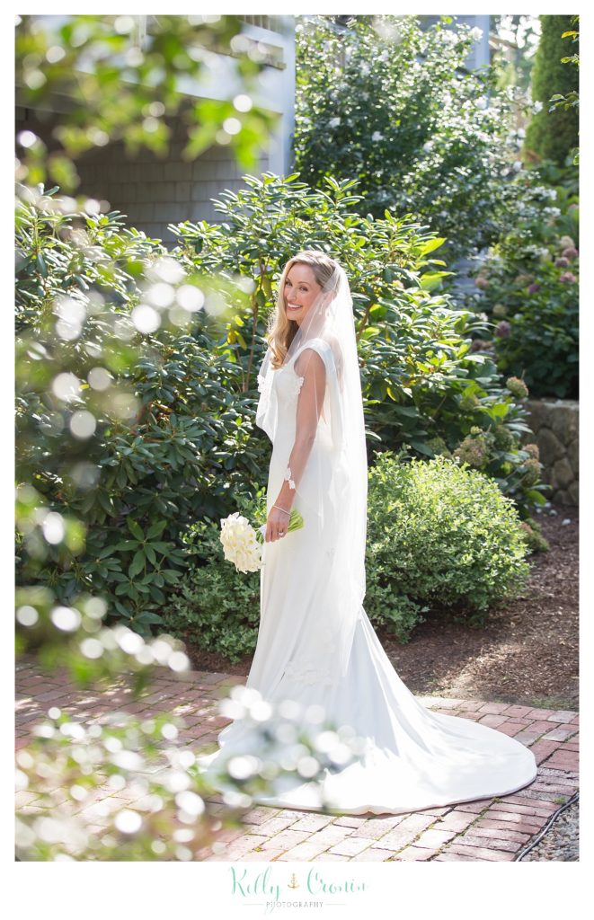 A bride smiles thinking about her wedding, a true Romance in Cape Cod. | Captured by Kelly Cronin Photography