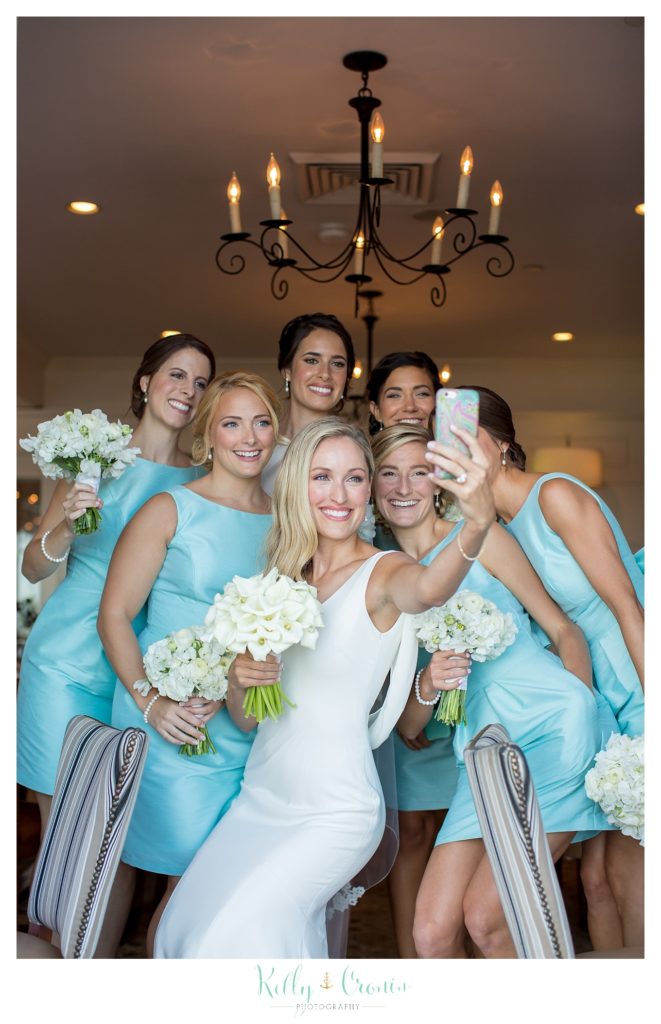 A bride takes a selfie with her bridal party before enjoying her Romance in Cape Cod. | Captured by Kelly Cronin Photography
