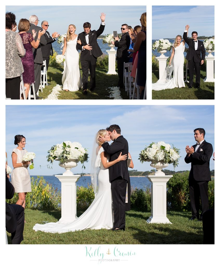 A bride and groom say vows and kiss, displaying an example of a Romance in Cape Cod. | Captured by Kelly Cronin Photography