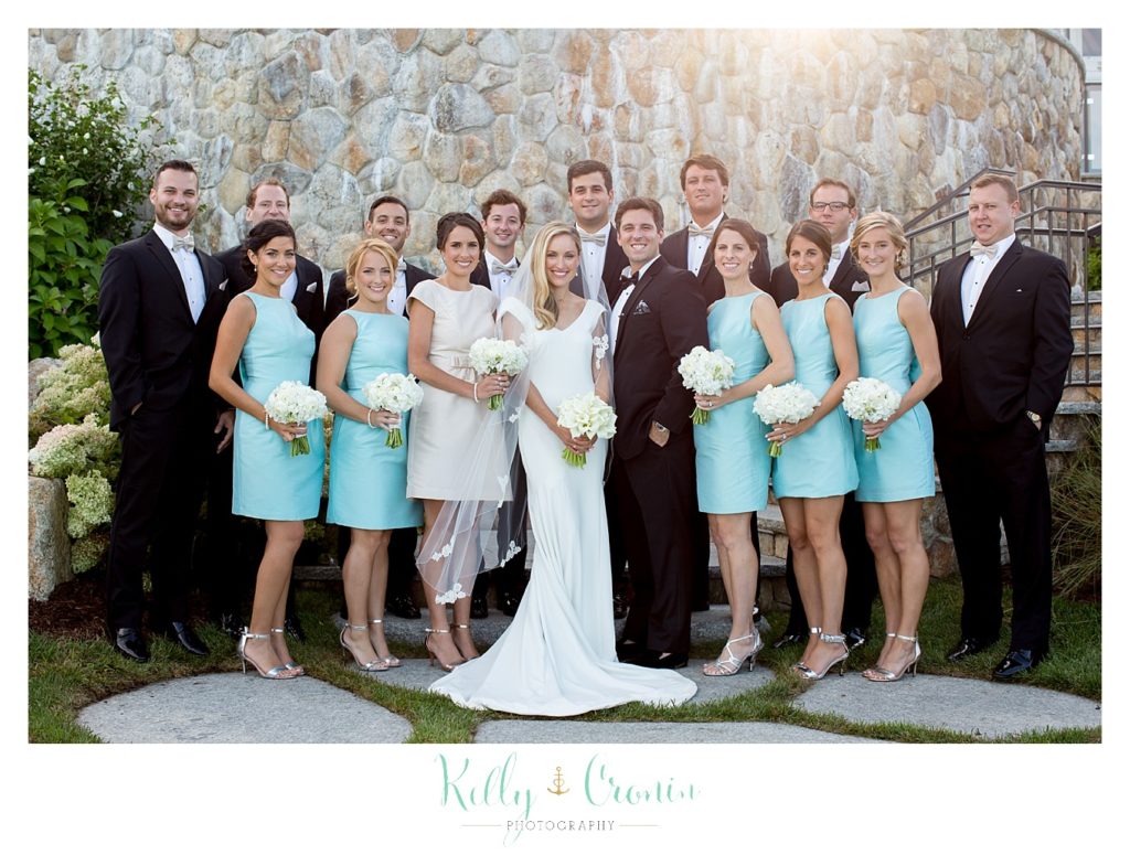 A wedding party celebrates a Romance in Cape Cod. | Captured by Kelly Cronin Photography