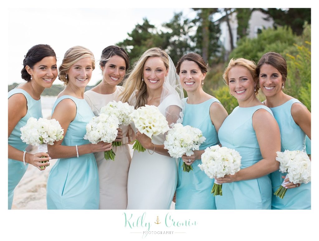 A bride smiles with her friends, thinking about her Romance in Cape Cod. | Captured by Kelly Cronin Photography