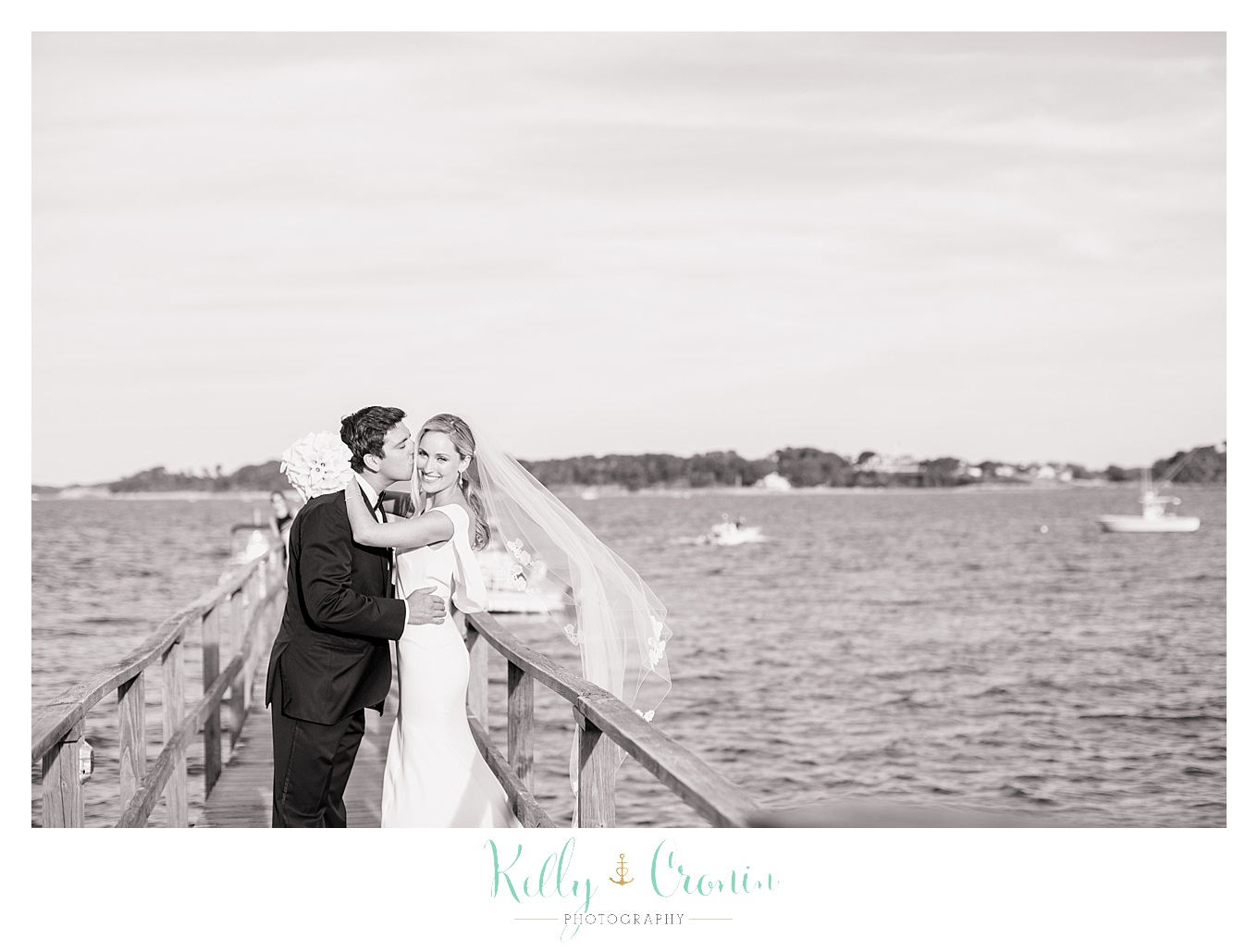 A man kisses his wife, creating Romance in Cape Cod. | Captured by Kelly Cronin Photography