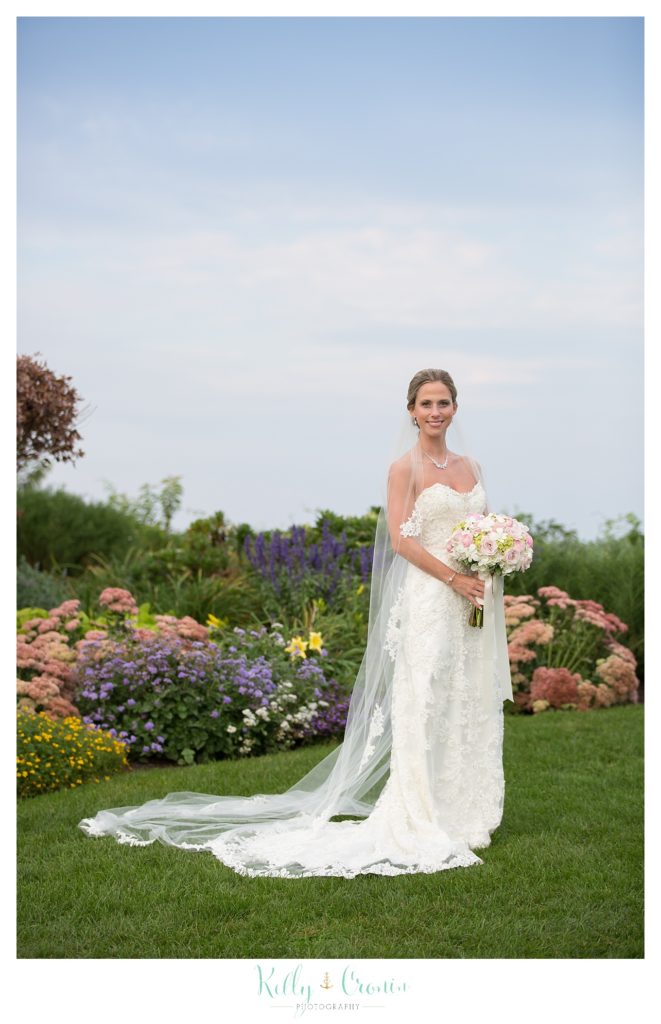 A bride holds her bouquet, wedding held at the White Cliffs Country club and captured by Kelly Cronin Photography