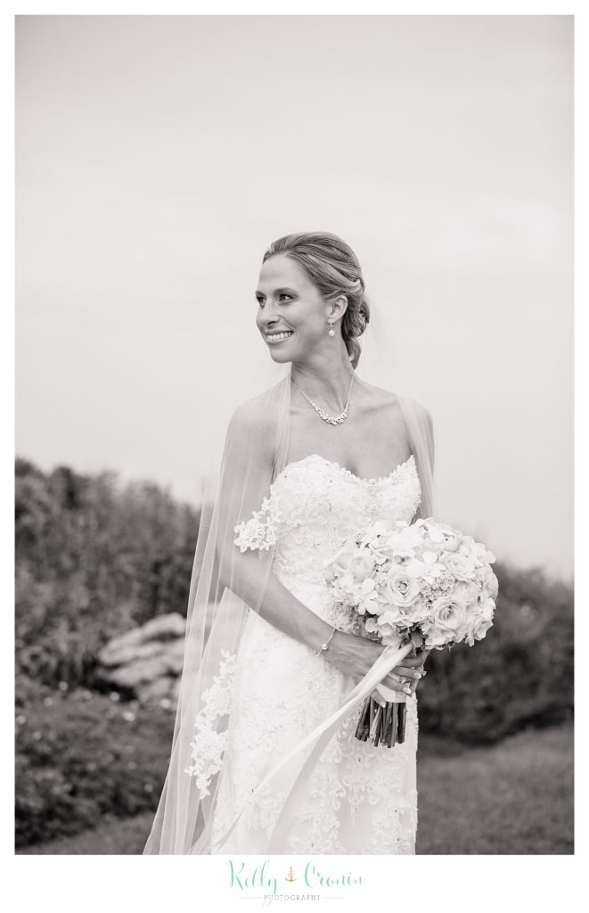 A bride looking over her shoulder, wedding held at the White Cliffs Country club and captured by Kelly Cronin Photography
