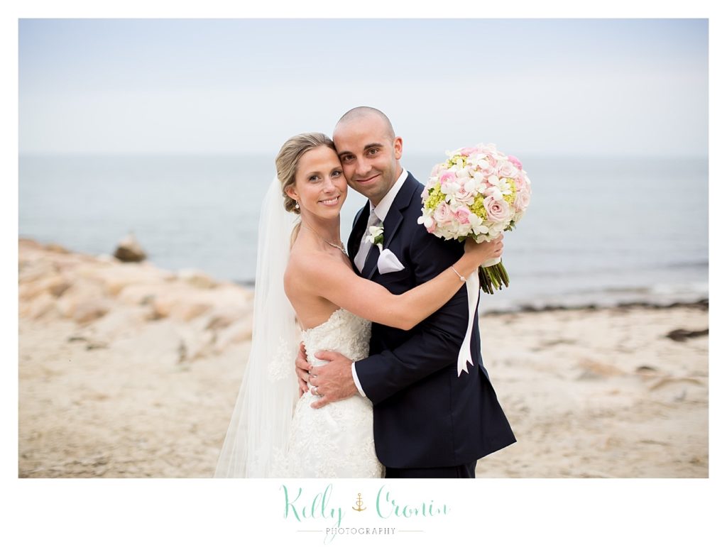 A groom hugs his bride, wedding held at the White Cliffs Country club and captured by Kelly Cronin Photography