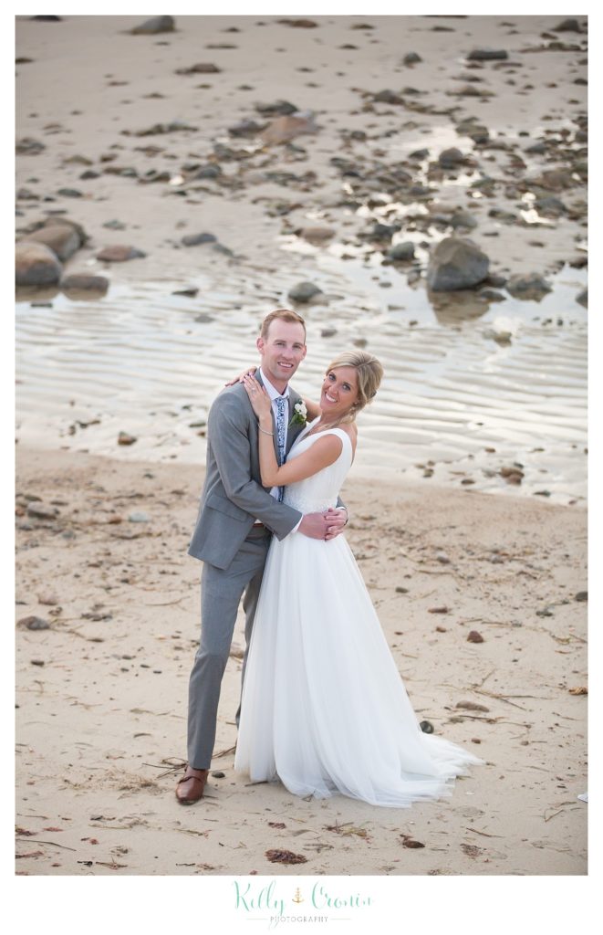 A newlywed couple sneak away to a beach near The Dennis Inn, captured by Kelly Cronin Photography