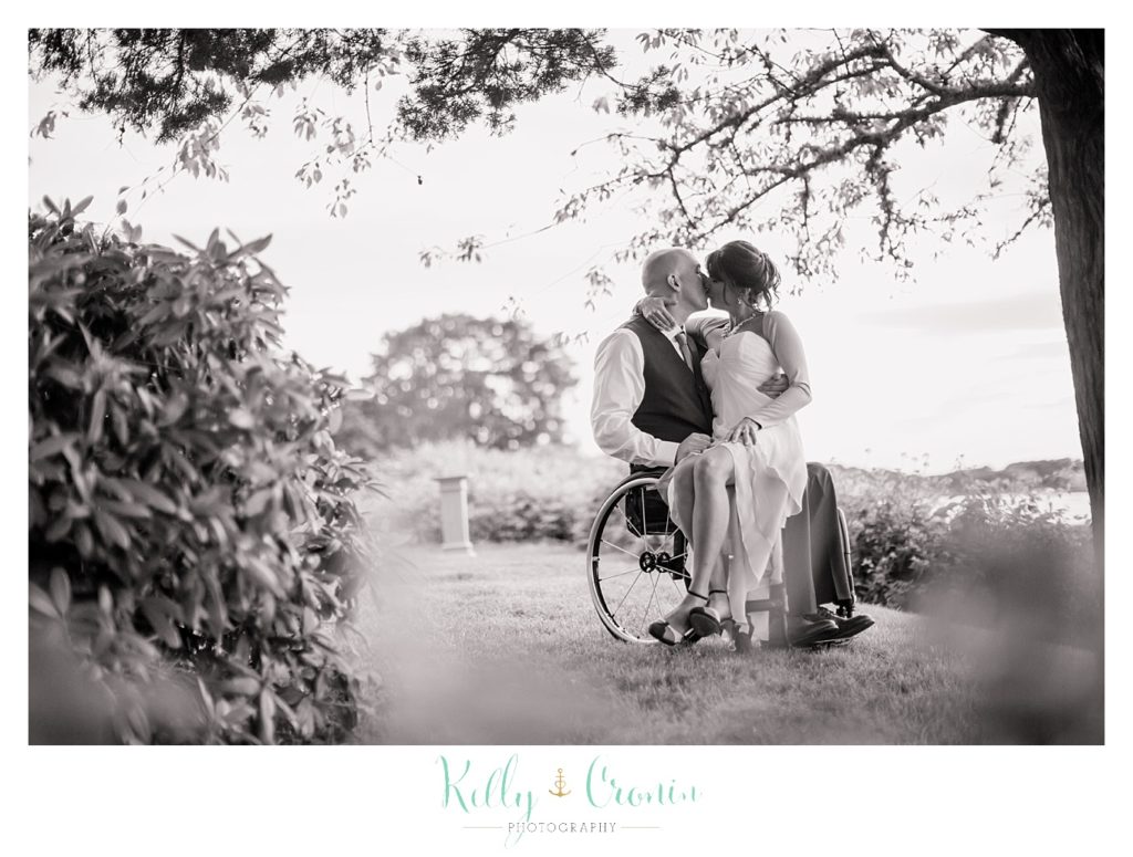 A bride sits on her groom's lap | Kelly Cronin Photography | Chatham Wedding Photographer