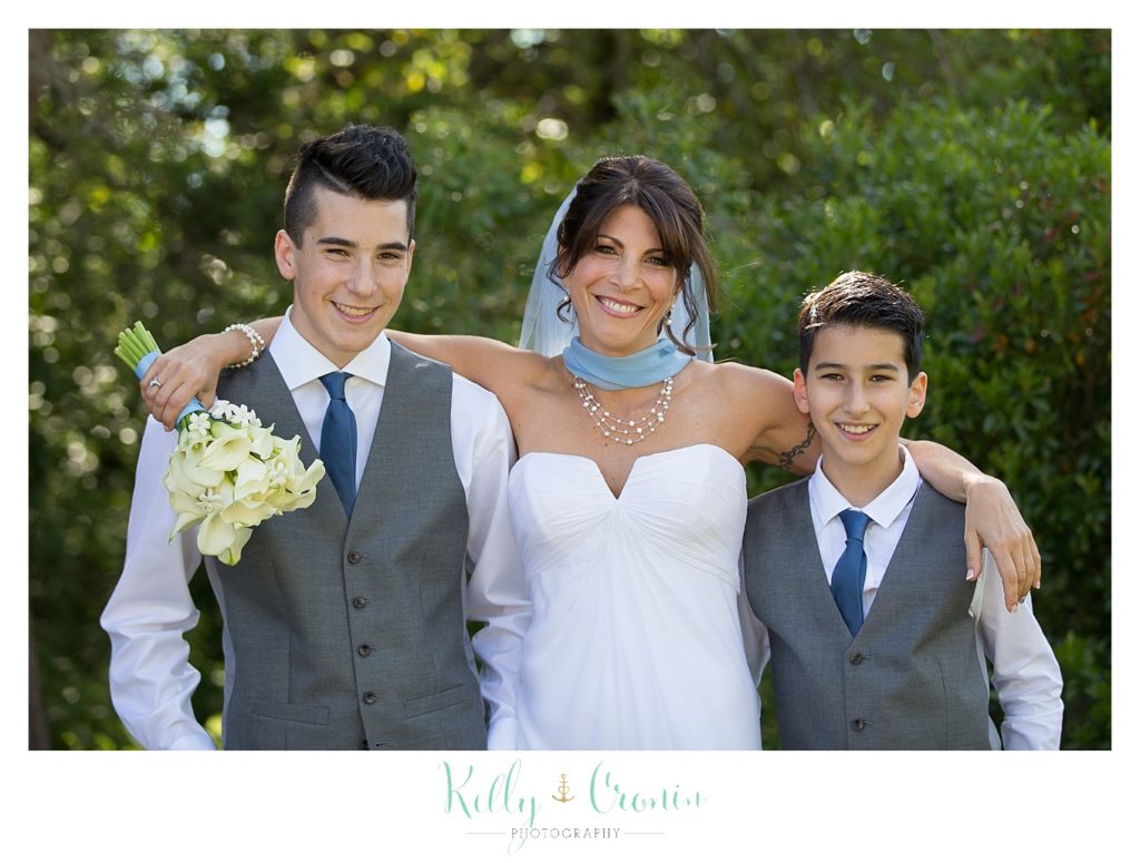 A bride hugs two boys | Kelly Cronin Photography | Chatham Wedding Photographer