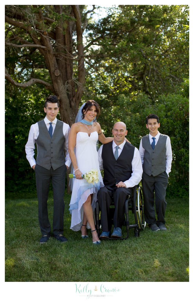 A newlywed couple poses for a photo with their sons | Kelly Cronin Photography | Chatham Wedding Photographer