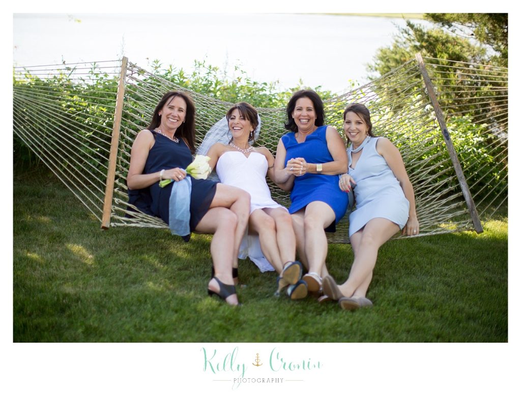 A bridal party swings in a hammock | Kelly Cronin Photography | Chatham Wedding Photographer
