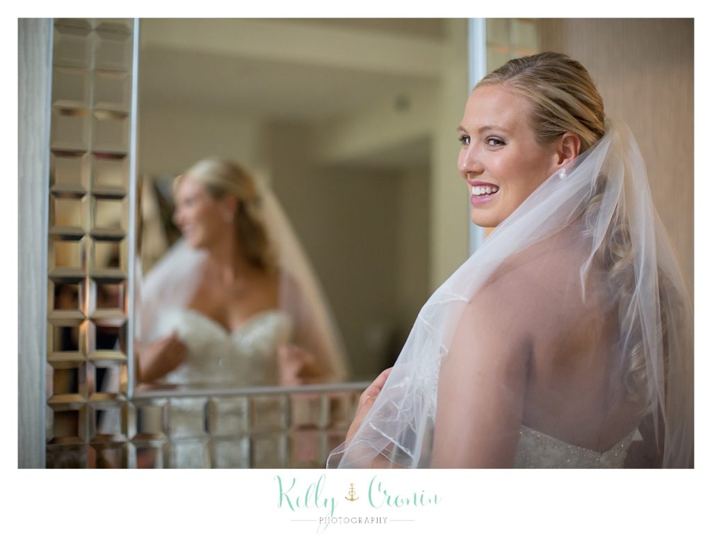 A bride looks over her shoulder | Kelly Cronin Photography | CJ's Ranch