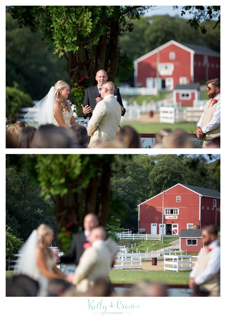 A bride and groom say their vows in front of a red barn | Kelly Cronin Photography | CJ's Ranch
