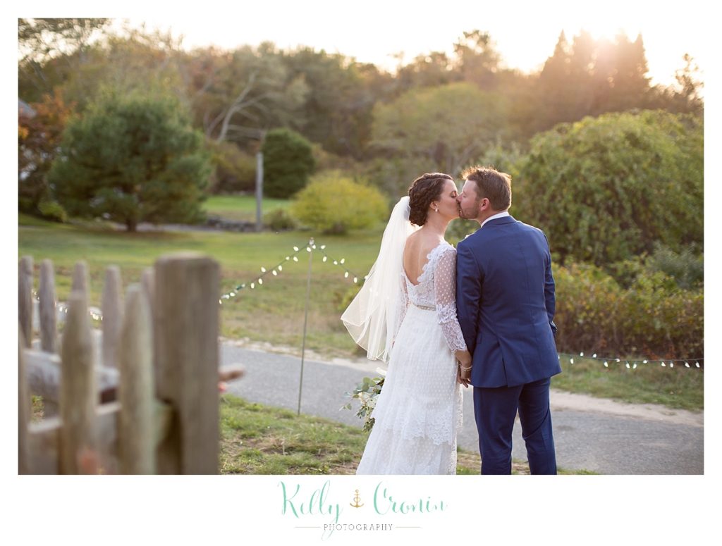 A couple kiss, this was a Mooncussers Tavern Reception, captured by Kelly Cronin Photography