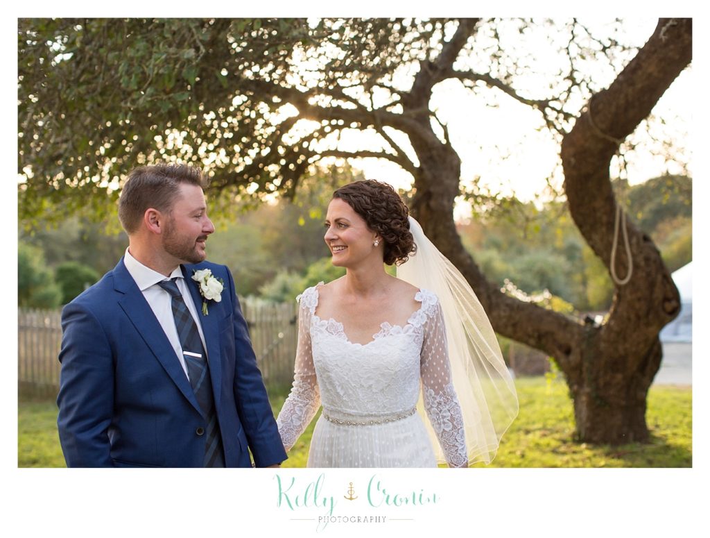A couple sneak away after their wedding, this was a Mooncussers Tavern Reception, captured by Kelly Cronin Photography
