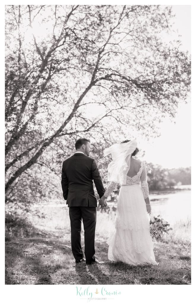 A man takes his bride for a walk, this was a Mooncussers Tavern Reception, captured by Kelly Cronin Photography