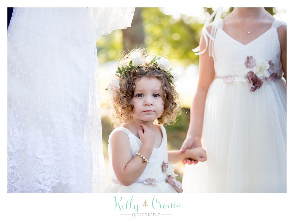 A flower girl waits, this was a Mooncussers Tavern Reception, captured by Kelly Cronin Photography