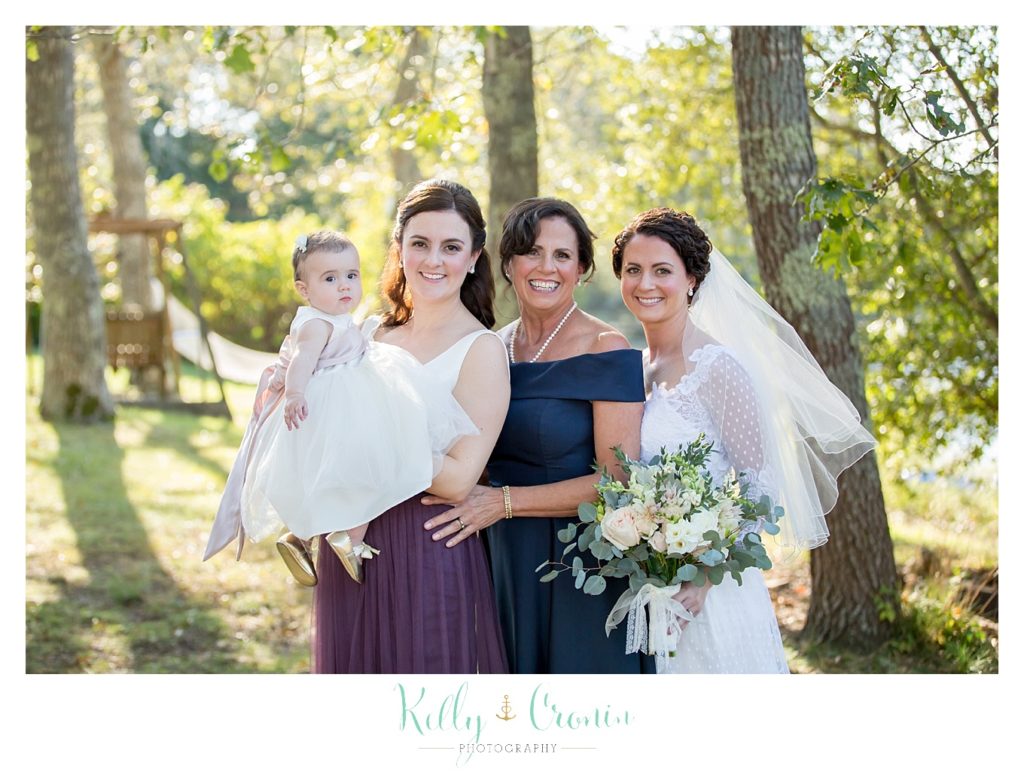 Women pose for a photo, this was a Mooncussers Tavern Reception, captured by Kelly Cronin Photography