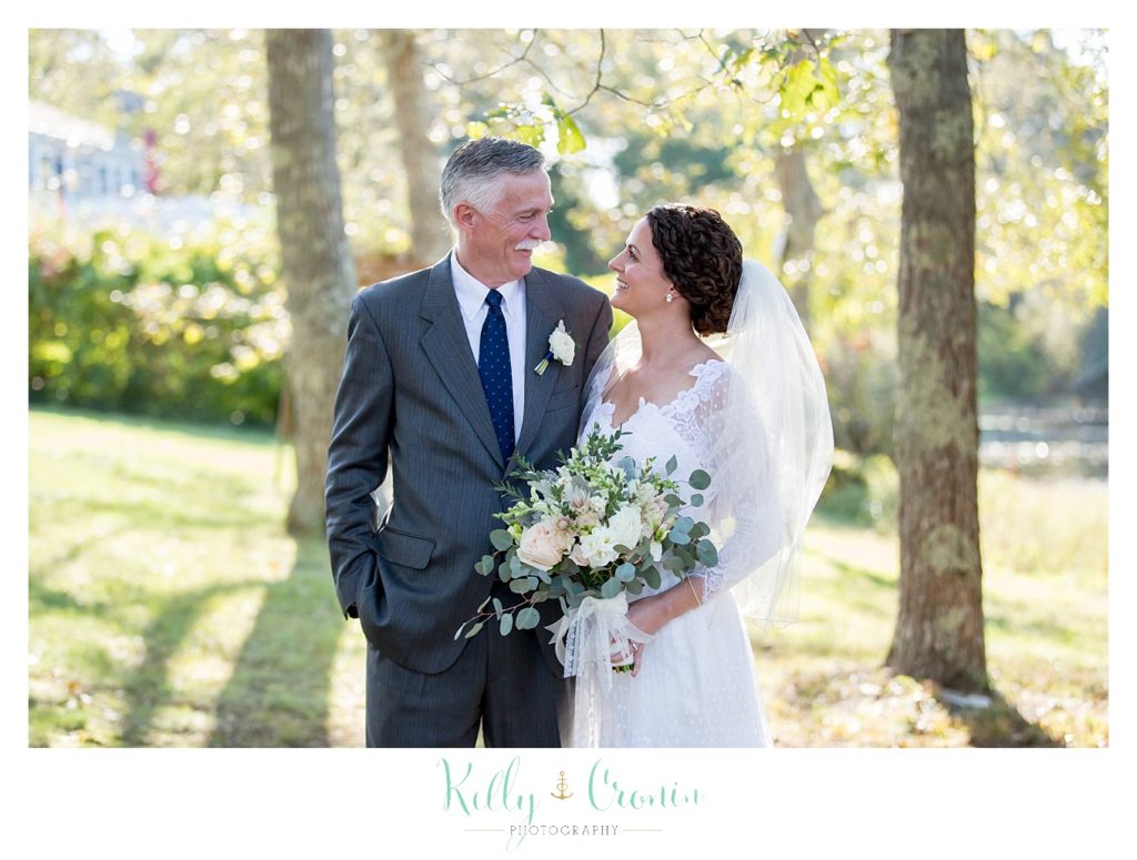 A bride talks with her dad, this was a Mooncussers Tavern Reception, captured by Kelly Cronin Photography