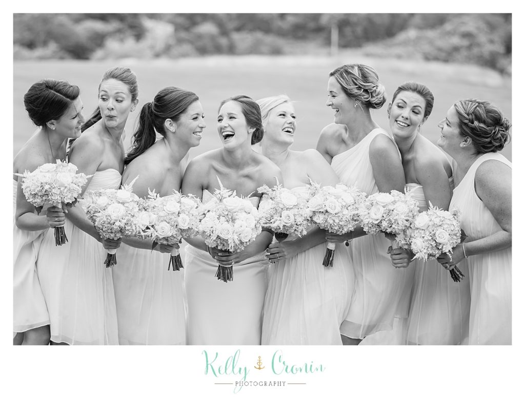 A bridal party laugh together | Kelly Cronin Photography | Lighthouse Beach