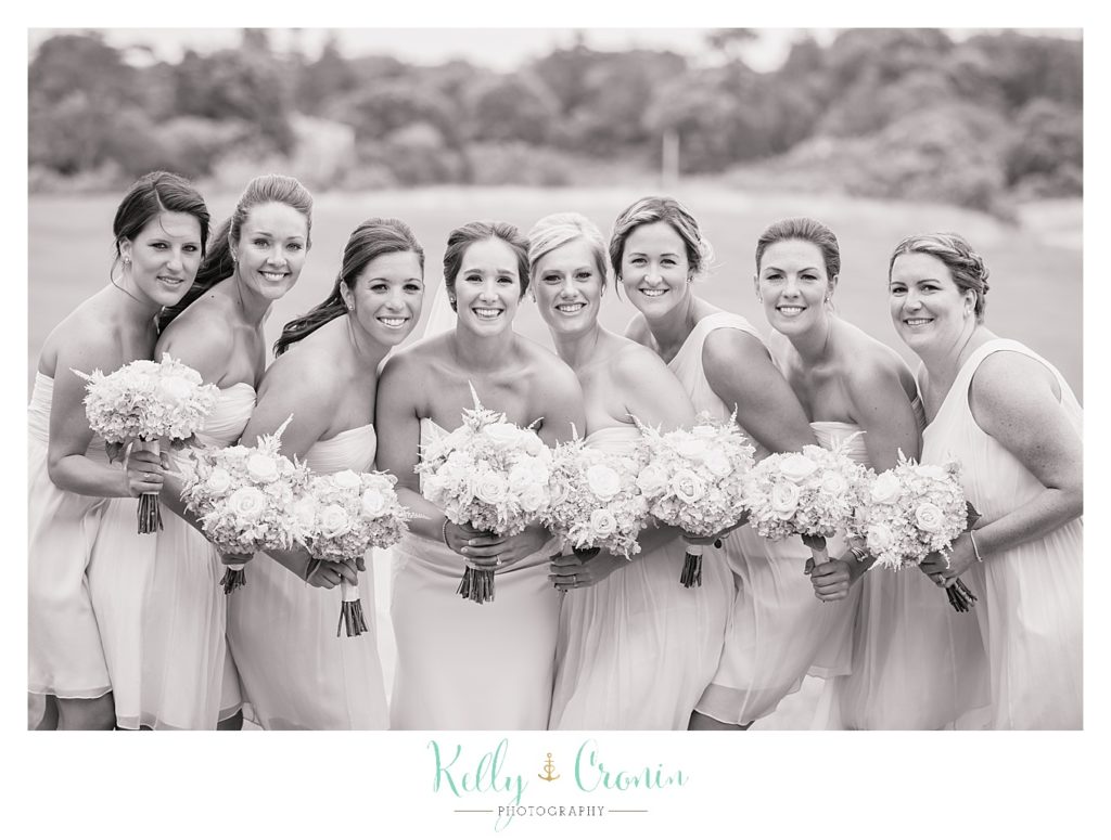 A bridal party pose for a photo | Kelly Cronin Photography | Lighthouse Beach