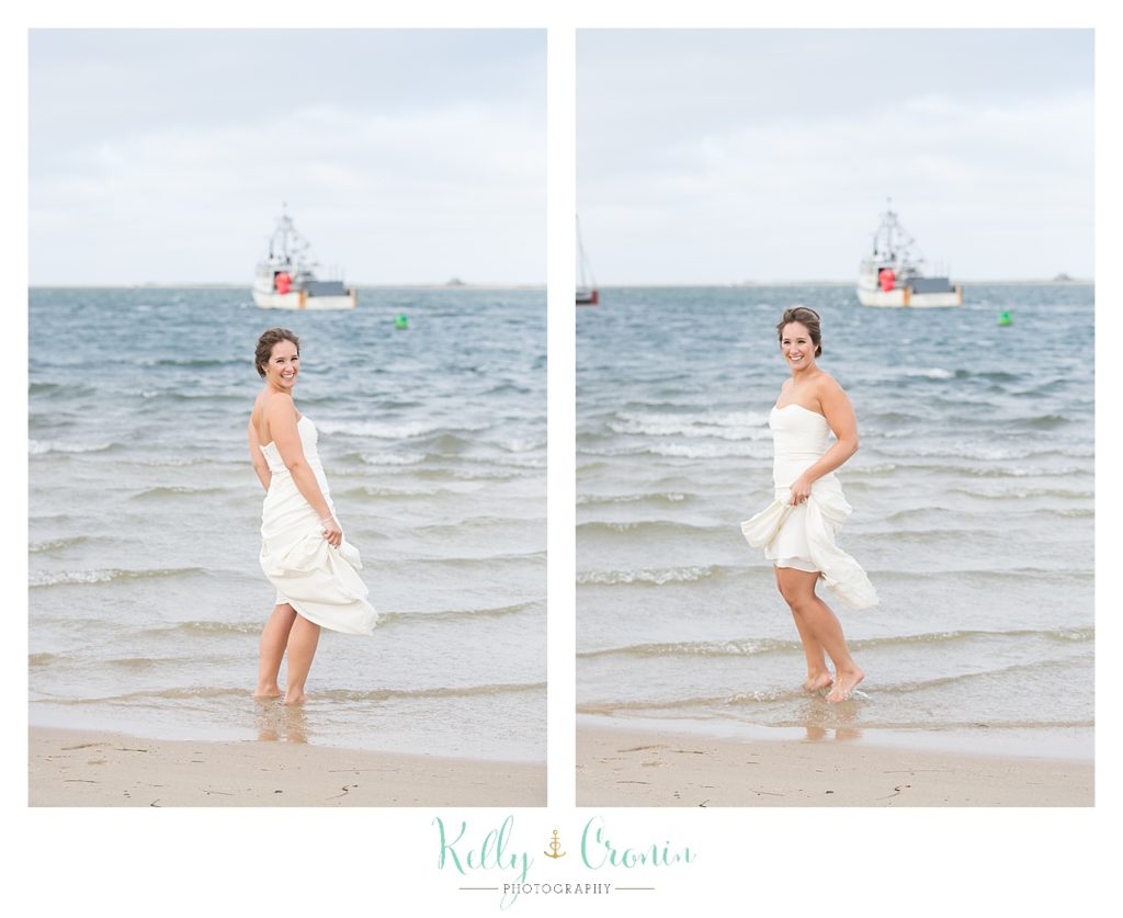 A bride splashes in the water | Kelly Cronin Photography | Lighthouse Beach