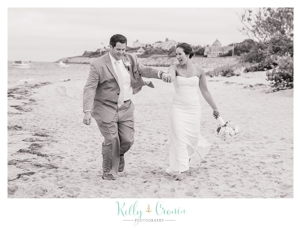 A groom leads his bride | Kelly Cronin Photography | Lighthouse Beach