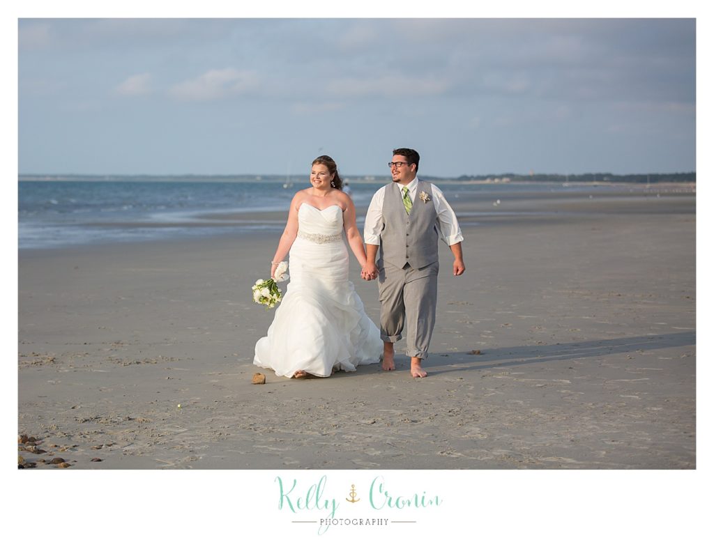 A bride walks with her groom | Kelly Cronin Photography | Ocean Edge Resort and Golf Club