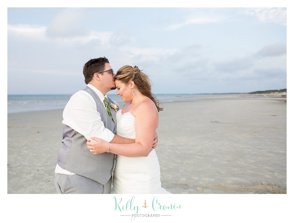 A man kisses his bride | Kelly Cronin Photography | Ocean Edge Resort and Golf Club