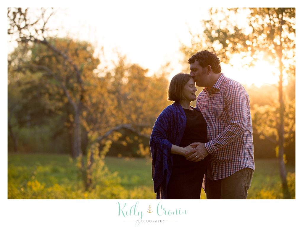 A man kisses his pregnant wife | Kelly Cronin Photography | Cape Cod Family Photographer 