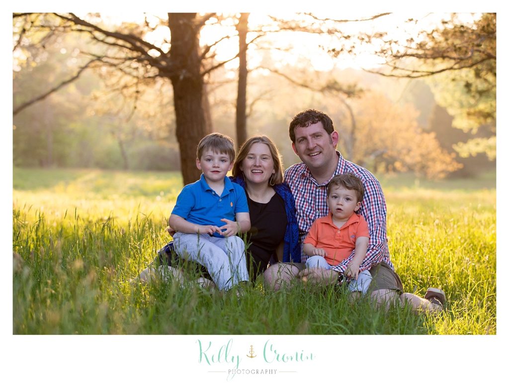 A family sits in a field together | Kelly Cronin Photography | Cape Cod Family Photographer 