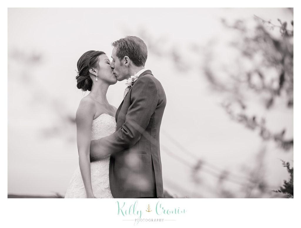 A groom kisses his bride | Kelly Cronin | Wing's Neck Light 