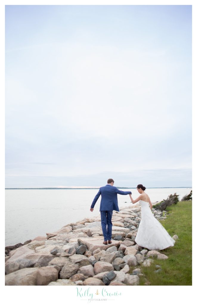A bride and groom run with delight | Kelly Cronin | Wing's Neck Light 