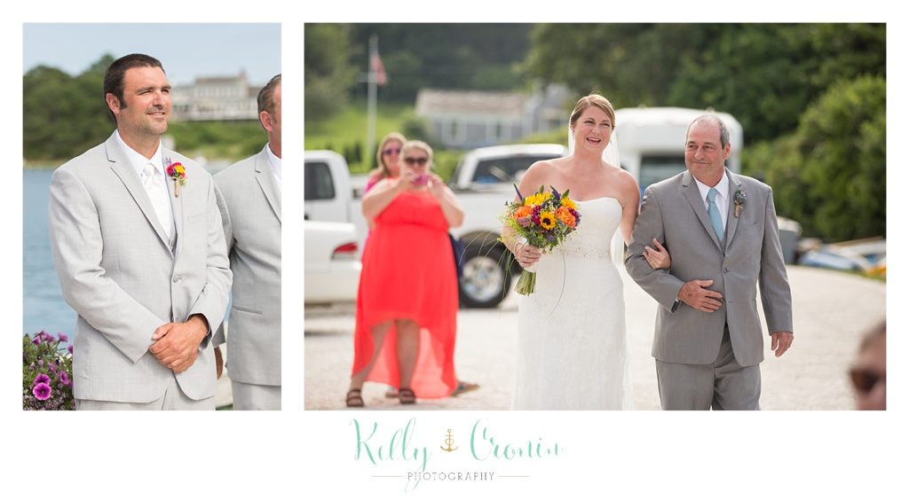 A bride is escorted to her groom  | Kelly Cronin Photography | Oyster River Landing