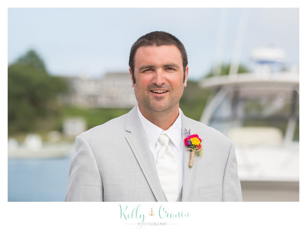 A groom smiles brightly  | Kelly Cronin Photography | Oyster River Landing