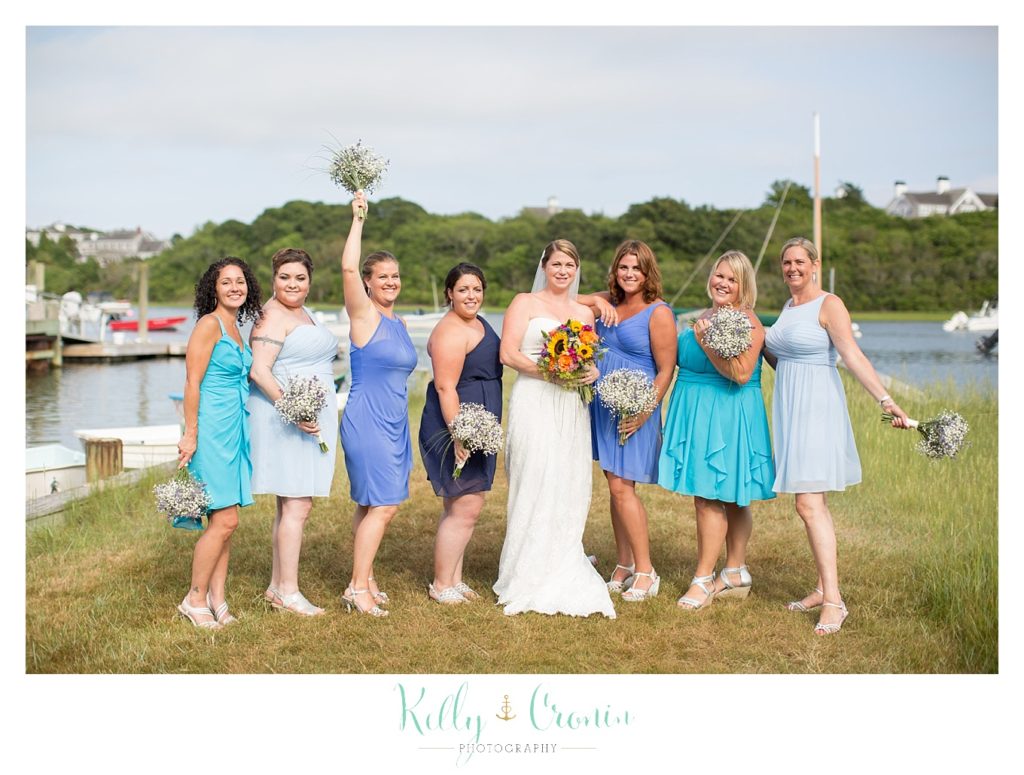 A bride celebrates with her party  | Kelly Cronin Photography | Oyster River Landing