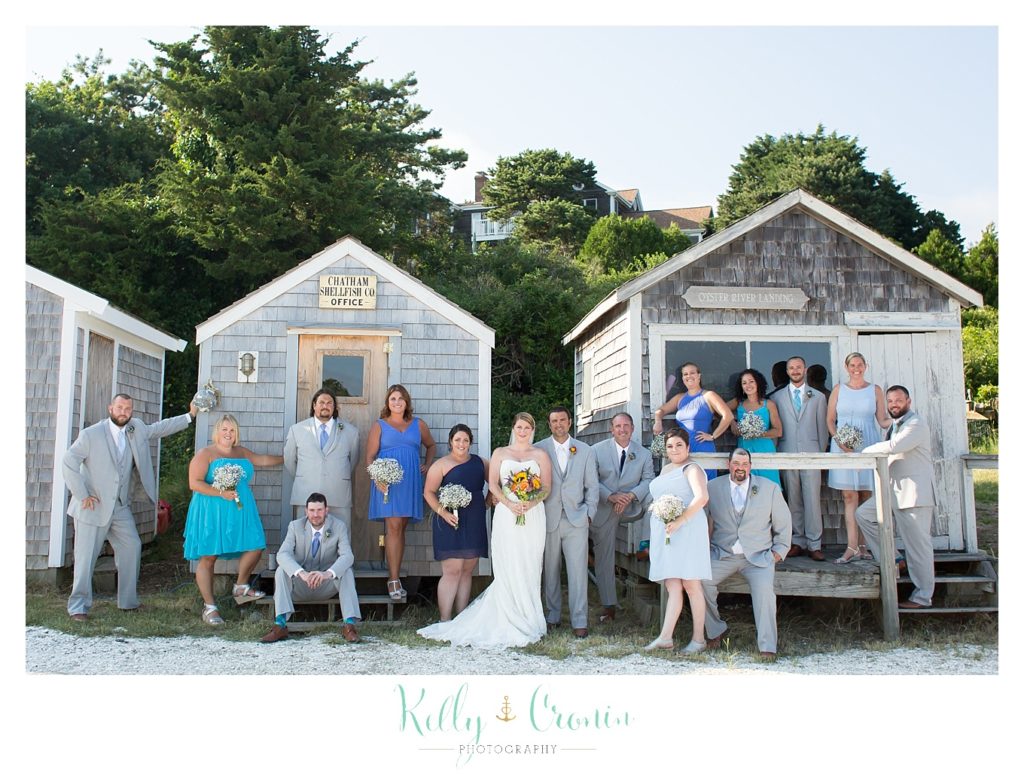A wedding party gets together for a photo  | Kelly Cronin Photography | Oyster River Landing