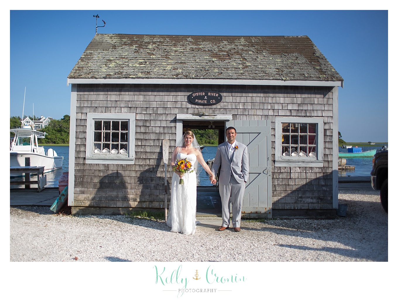A bride and groom hold hands | Kelly Cronin Photography | Oyster River Landing
